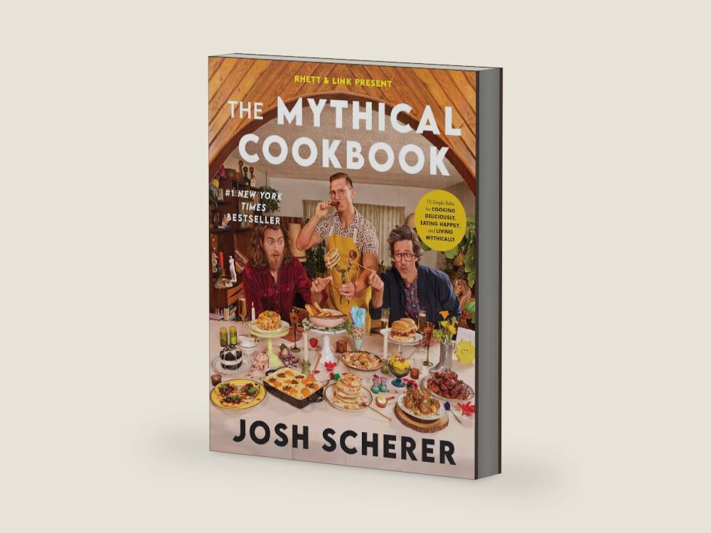Rhett & Link Present: The Mythical Cookbook: 10 Simple Rules for Cooking Deliciously, Eating Happily, and Living Mythically – A Hilarious Recipe Collection from the Hit Web Series by Josh Scherer | barcode:9780063323964 | source:'9780063323964-right-three-quarter.jpg