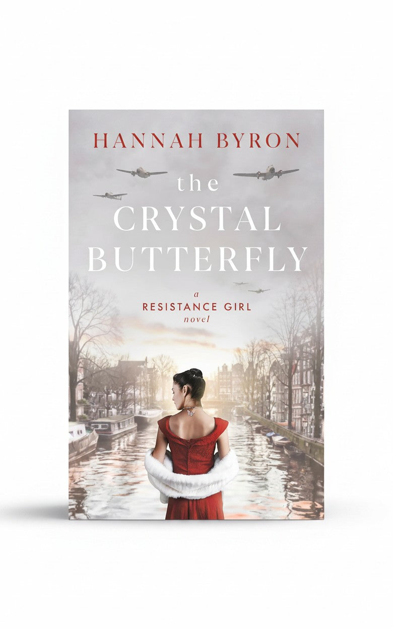 BestBuyBook cover of The Crystal Butterfly by Hannah Byron featuring a ballerina in a red dress by an Amsterdam canal.