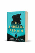 BestBuyBook paperback edition of The Threads Remain by Glenn Shapiro with a blue silhouette cover design.